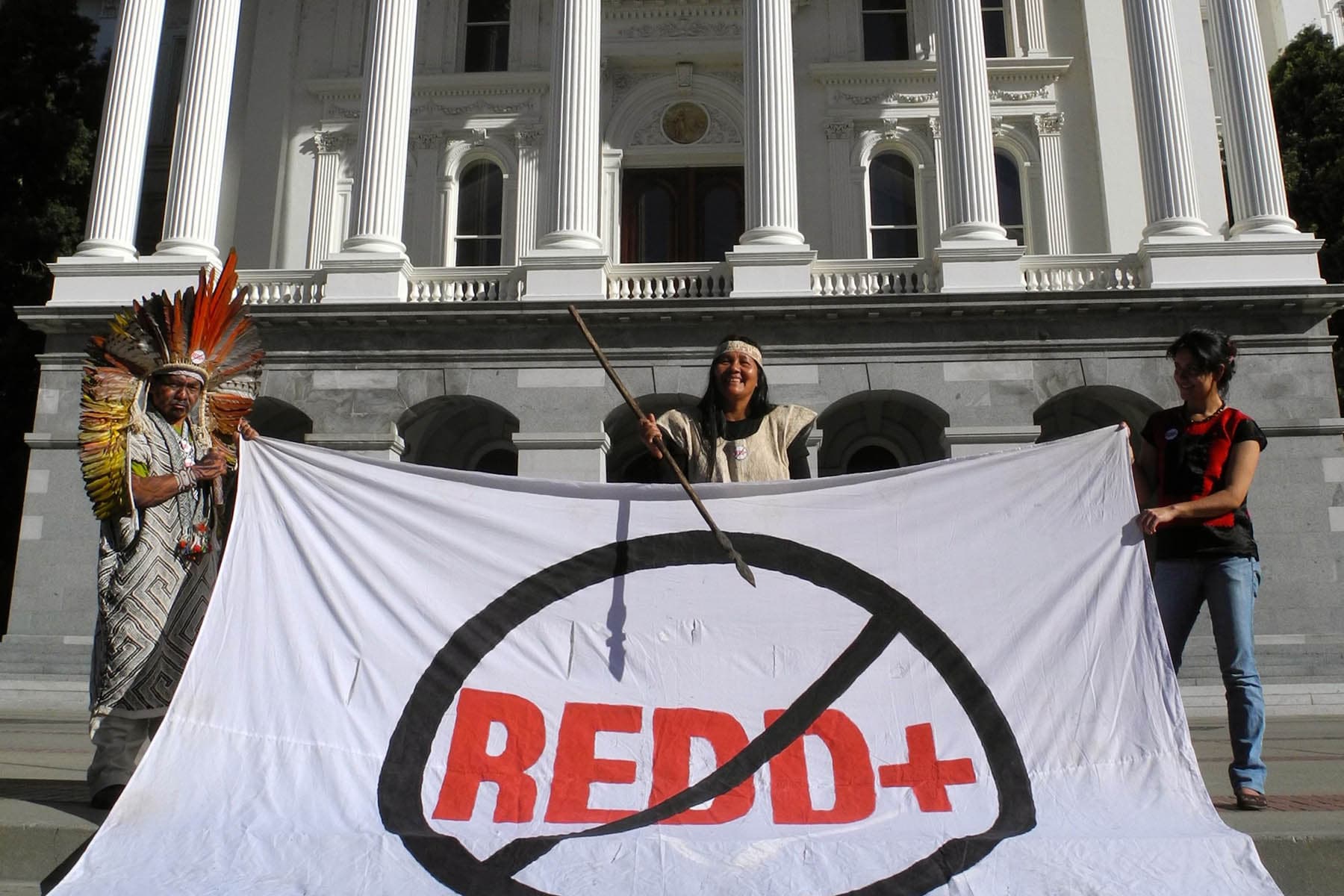 Members of the movement holding a No REDD+ banner