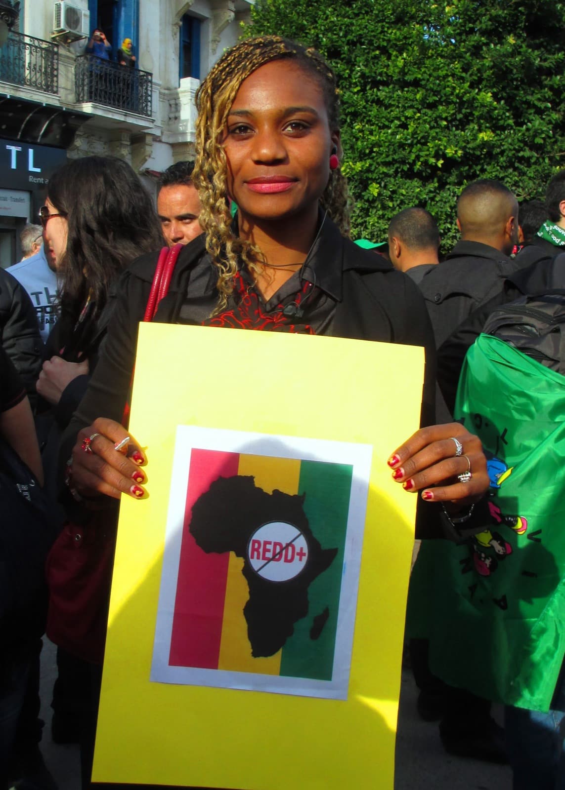 A member of the network holding the No REDD in Africa placard at the World Social Forum march, Tunis, 2013